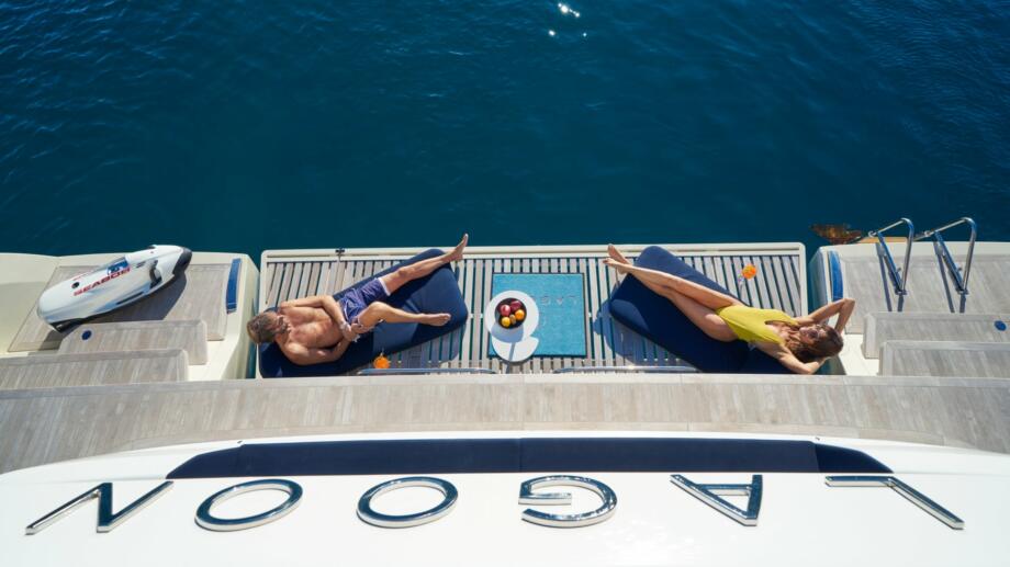 Yacht Charter Management Program Croatia the owner couple sunbathing on the platform of Lagoon Sixty5