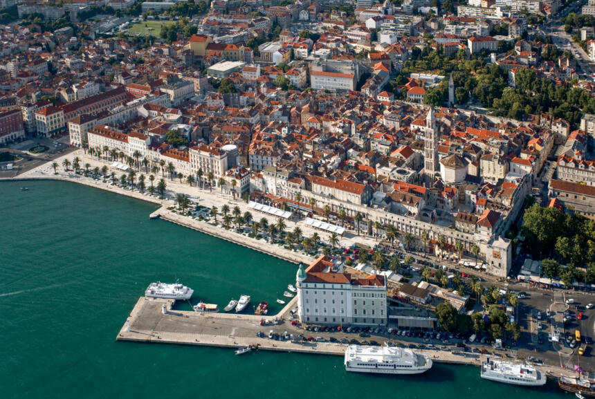 Split aerial view of the waterfront and palace