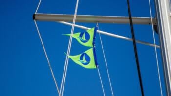 Green sail flags on Nava Boats for sustainable sailing in Croatia