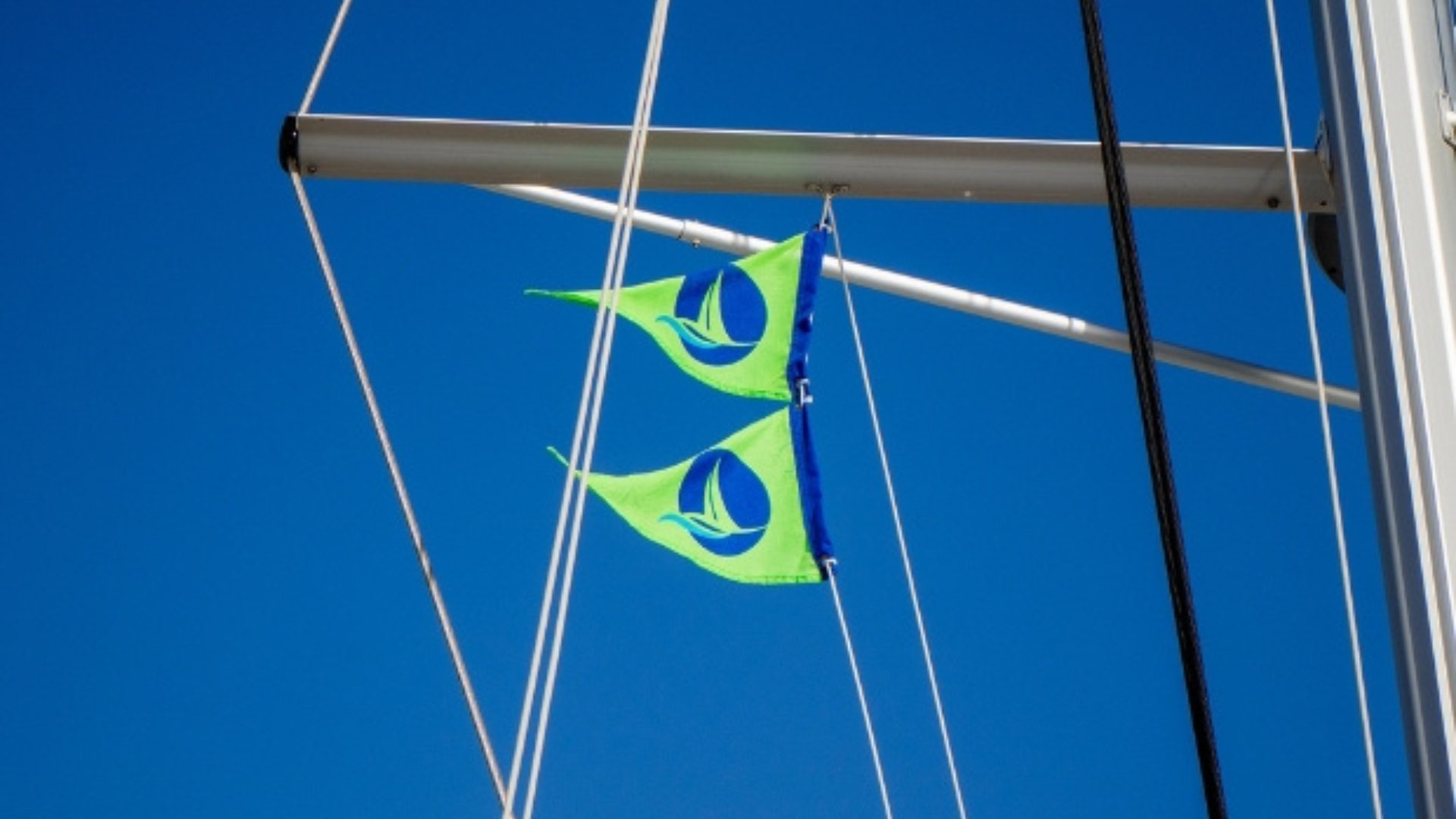 Green sail flags on Nava Boats for sustainable sailing in Croatia