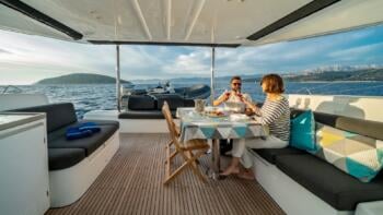 couple drinking wine on board charter yacht in croatia